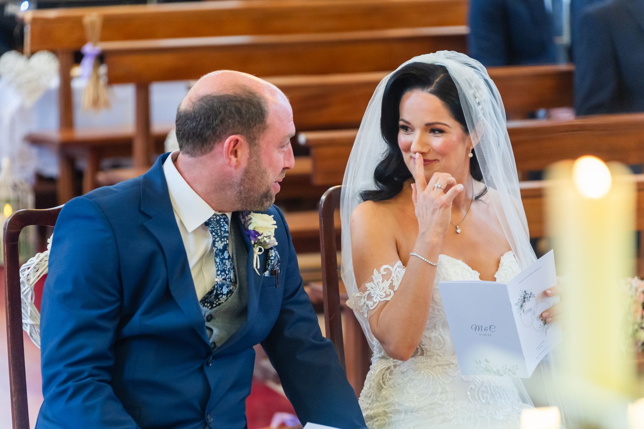 Bride walking down a sunlit aisle with the groom and celebrant waiting at the altar